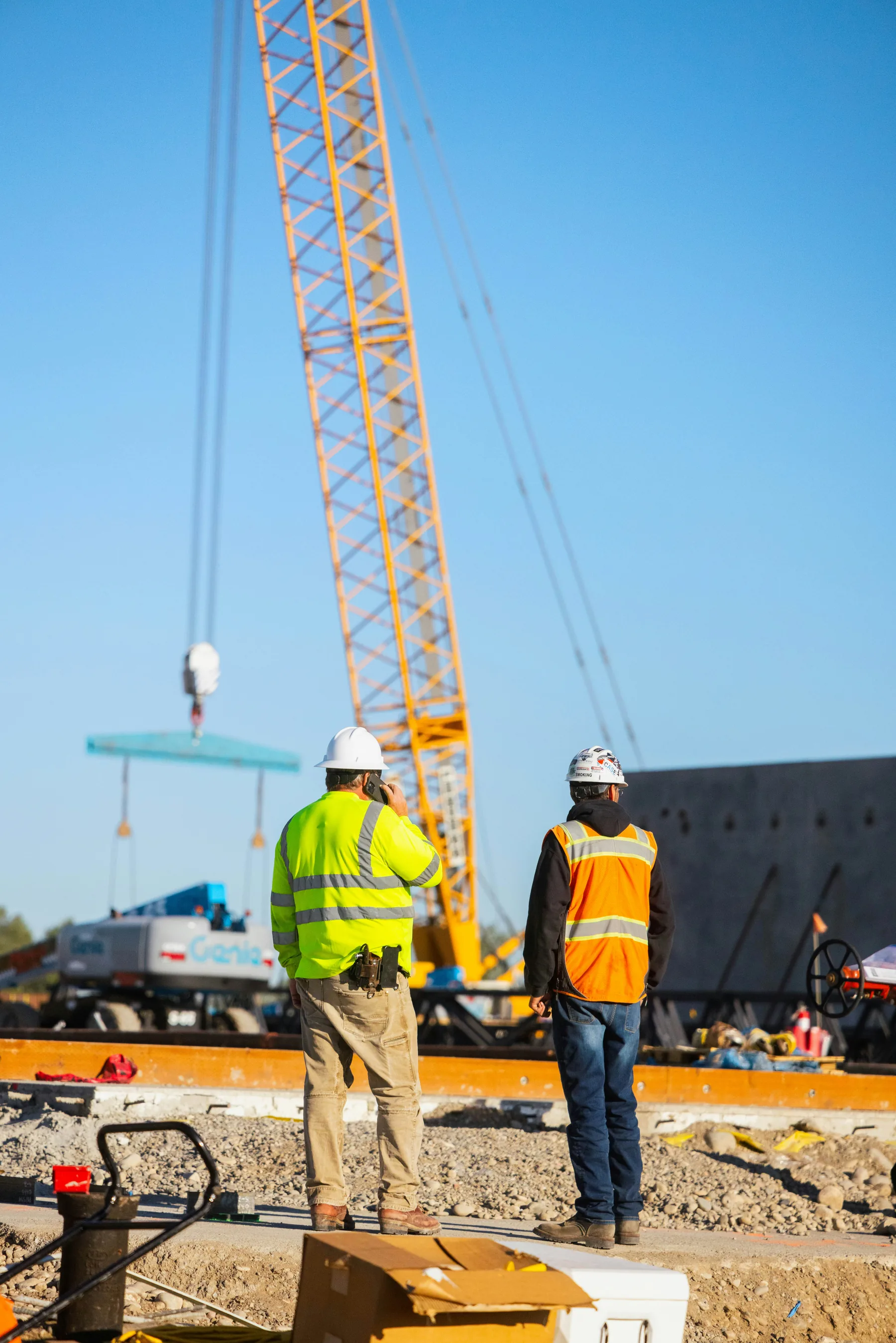 Workers observing a crane lift